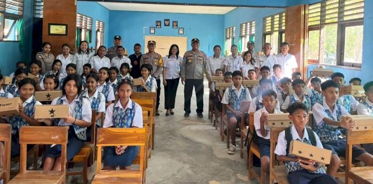 Kapolres Rote Ndao AKBP Mardiono saat membagikan sepatu bagi anak sekolah di pulau  terluar 