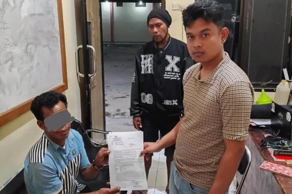 Tersangka menerima surat sebelum ditahan di sel Polres Sumba Barat Daya 